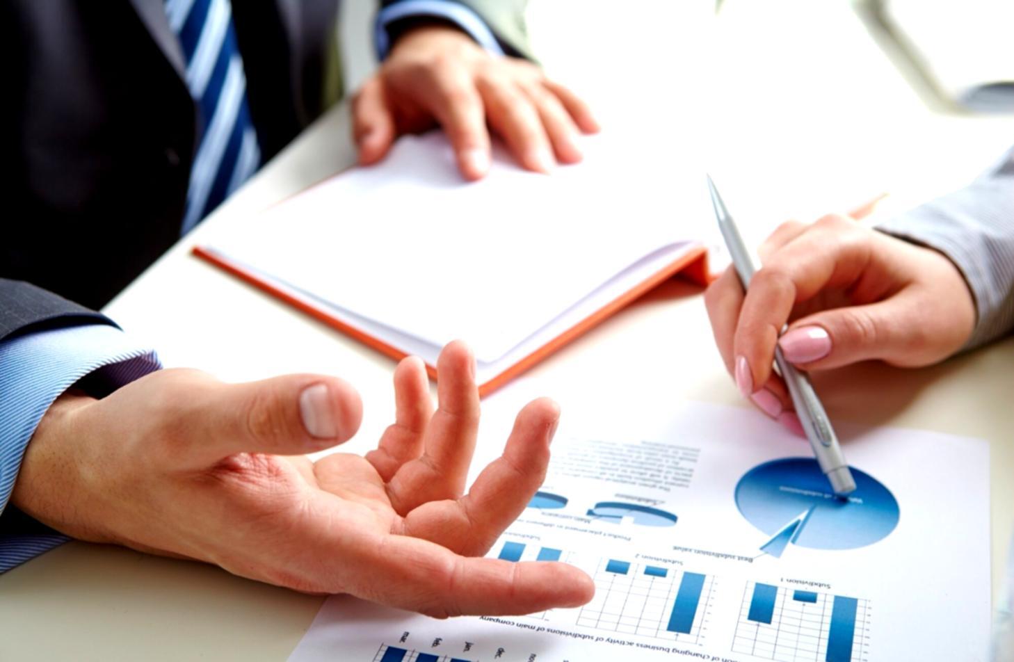 Financial analysis workspace with multiple data screens and market charts